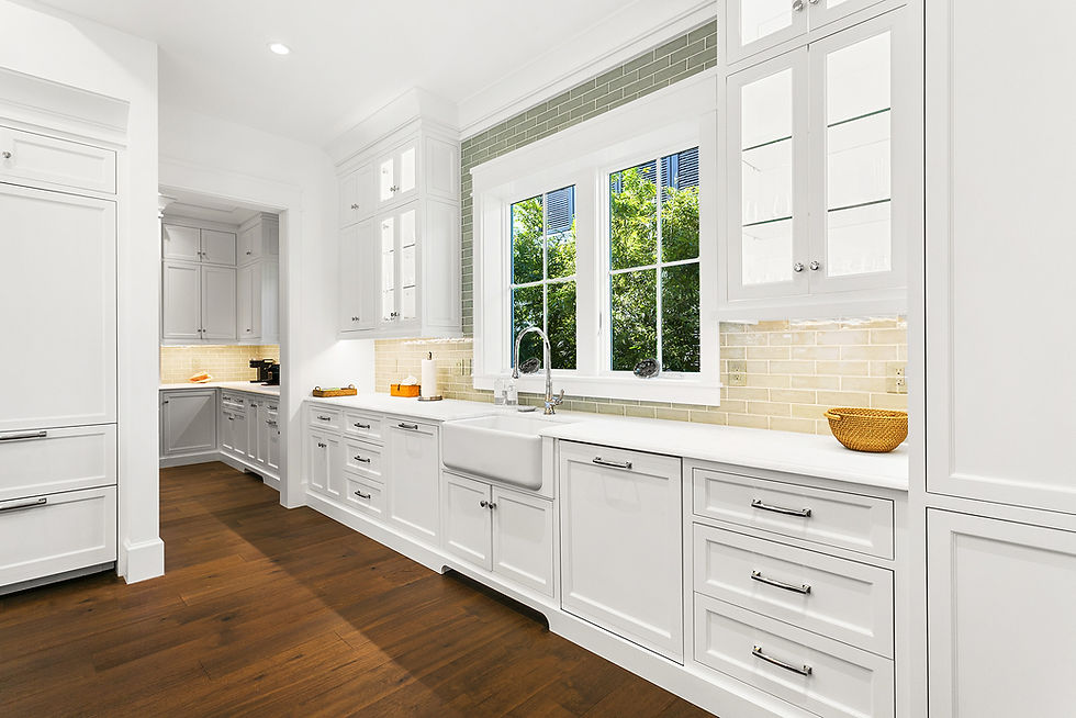 hardwood floors contrast with a bright white counter and cabinetry