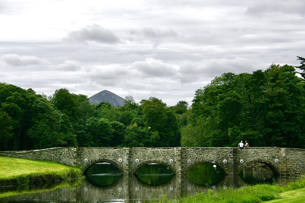 Stone bridge over Carrowbeg river with Croagh Patrick in the distance.  Croagh Patrick is a famous pilgrimage mountain that Saint Patrick was to have climbed. 