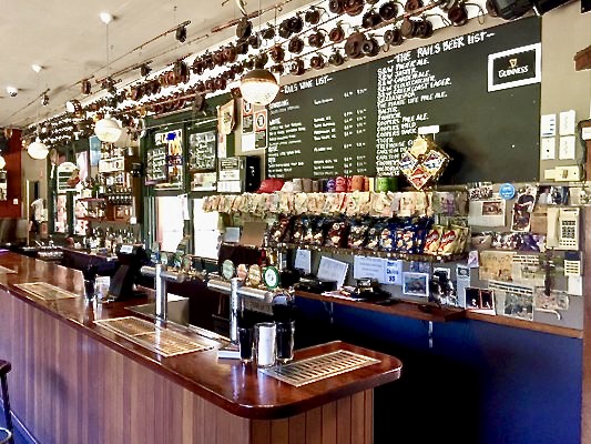 Inside Railway Bar Byron Bay - fishing reels on the wall above the bar