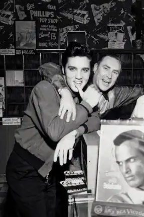 Elvis Presley with disc jockey Dewey Phillips in1957 at a Memphis record shop.