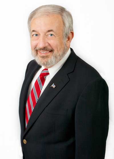 Smiling man in a suit and red striped tie