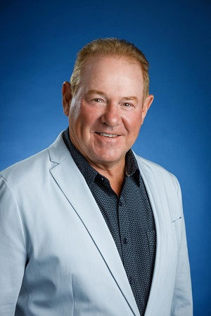 Smiling middle-aged man in a light blue blazer