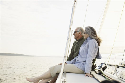 Senior couple relaxing on a sailboat at sea
