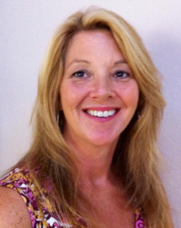 Smiling blonde woman in a purple patterned top