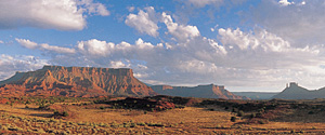 Scenic desert landscape with red mesa and clouds