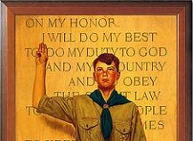Boy Scout giving a salute with the Scout Oath in background