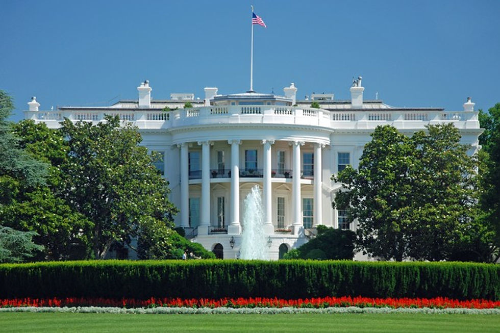 The White House South Portico with fountain and flag.