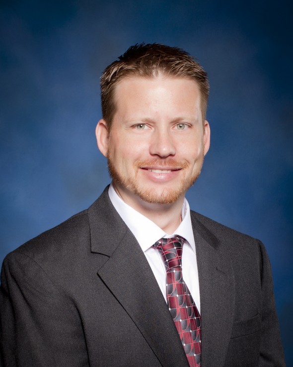 Jeremy Vernor wearing a suit and patterned tie.