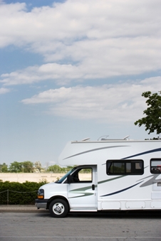 White motorhome parked under a blue sky