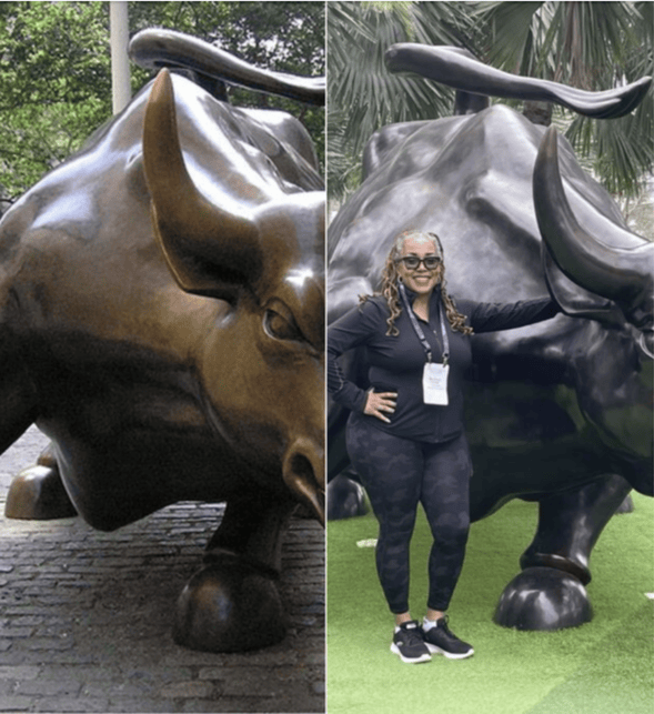 Woman posing with a Charging Bull bronze statue