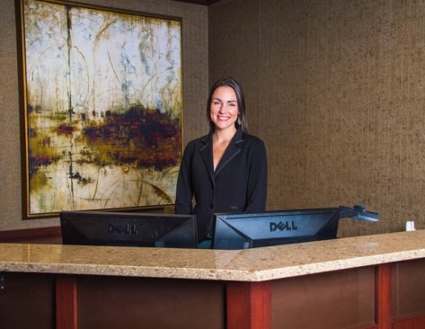 Smiling receptionist at the modern office front desk