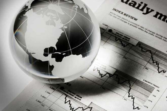 Crystal globe resting on financial news and stock charts