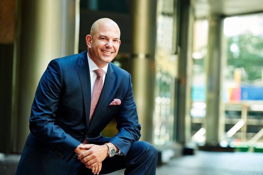 Smiling professional man in a suit for The Roth 401k Guide