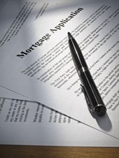 Pen resting on a mortgage application form