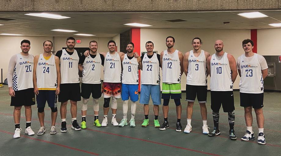 Eight basketball players in BAR jerseys standing in a line.