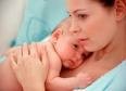 Mother holding a newborn baby close to her chest