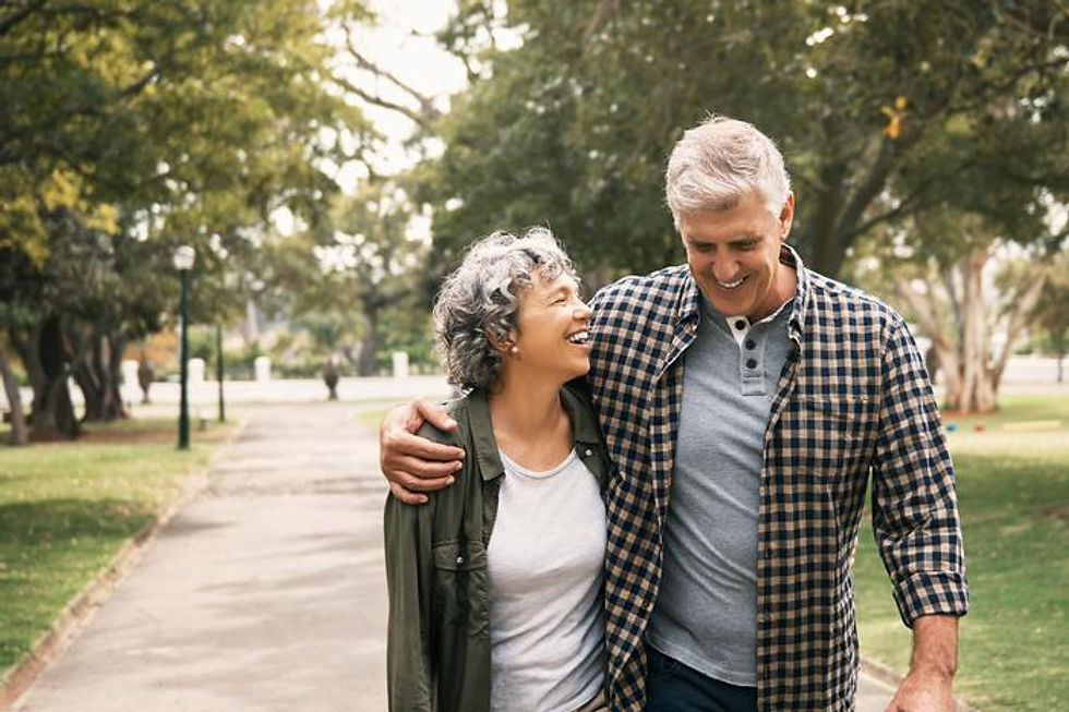 Senior couple walking and smiling together in a park