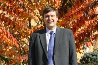 Professional man in a suit with autumn leaves background