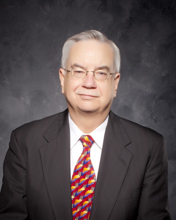 Portrait of an advisor in a suit and patterned tie