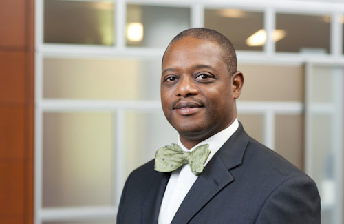 Smiling man in a suit and bow tie