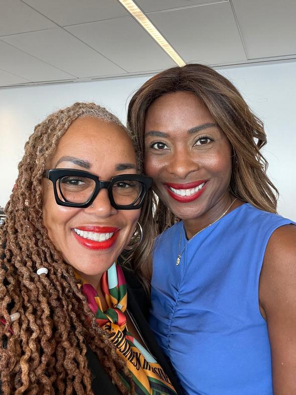 Two smiling women posing together for a portrait