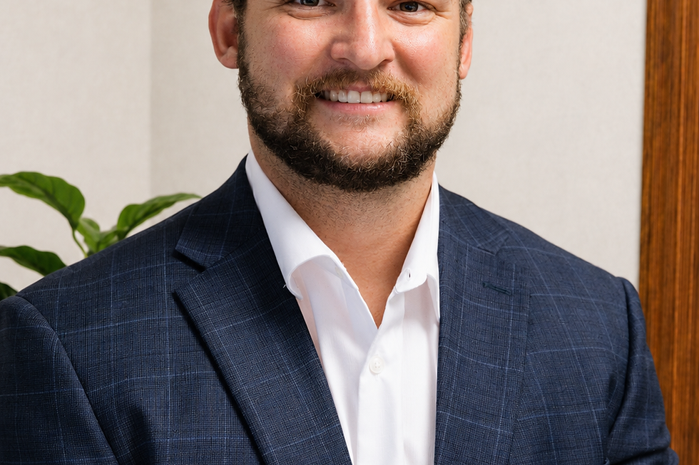 Bret Klabunde smiling in a blue suit and white shirt