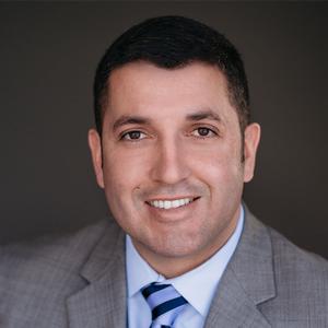 Professional portrait of a smiling male associate