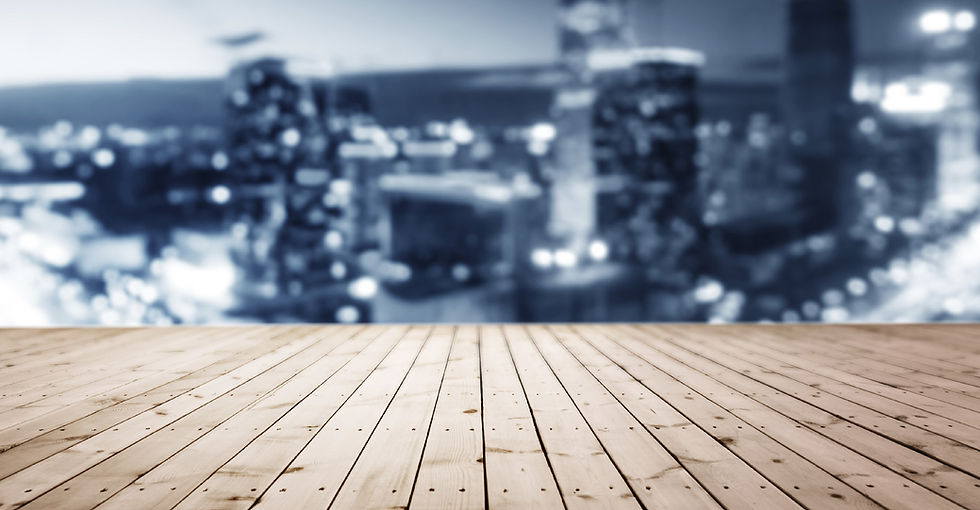 Wooden floor with blurred city lights background