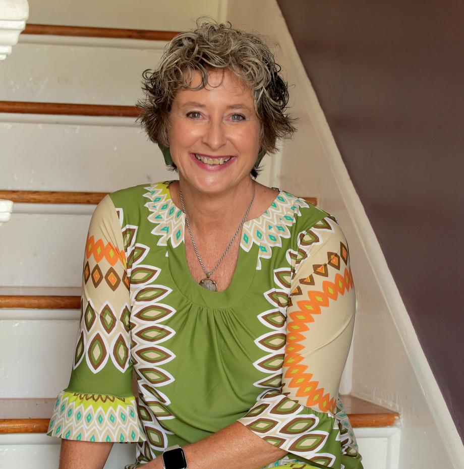 Smiling woman with short curly hair on stairs