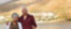 Smiling couple with scenic mountain and water background