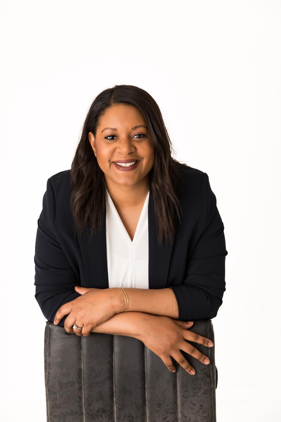 Smiling professional woman in a dark blazer