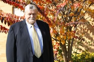 Professional headshot of a qualified expert in a suit