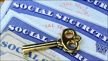 Golden key resting on Social Security cards