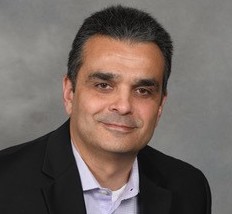 Portrait of a smiling male advisor in a black blazer.
