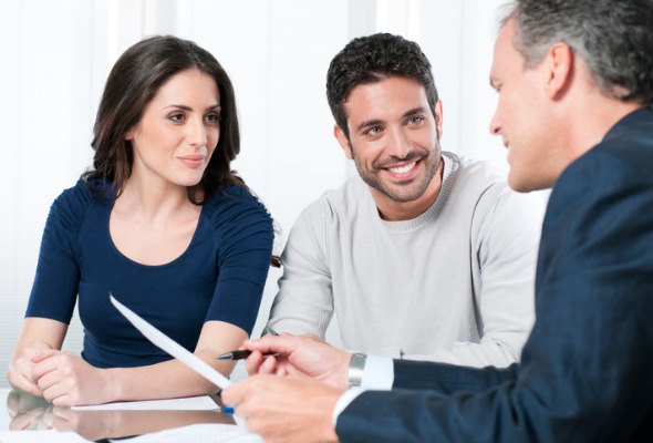 Couple meeting with a professional for client introduction.