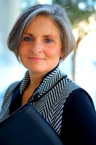 Professional business owner with grey hair holding a folder