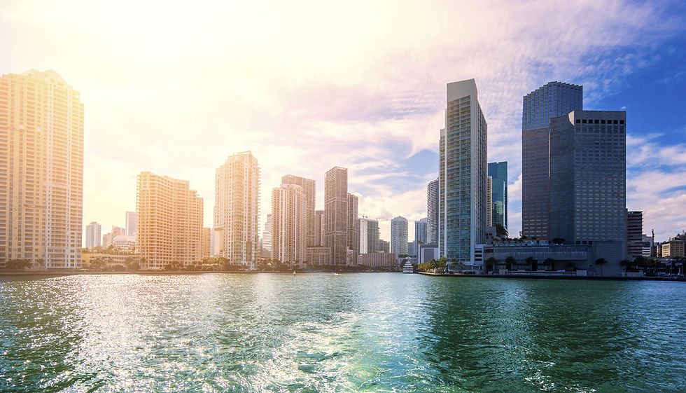 City skyline reflecting on water at sunset