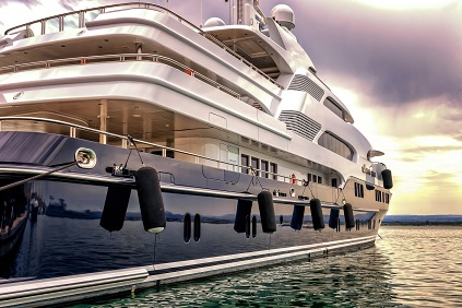 Large luxury yacht on the water at sunset.