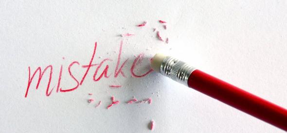 Pencil eraser removing the handwritten word mistake