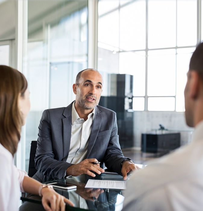 Financial advisor discussing retirement strategy with a couple