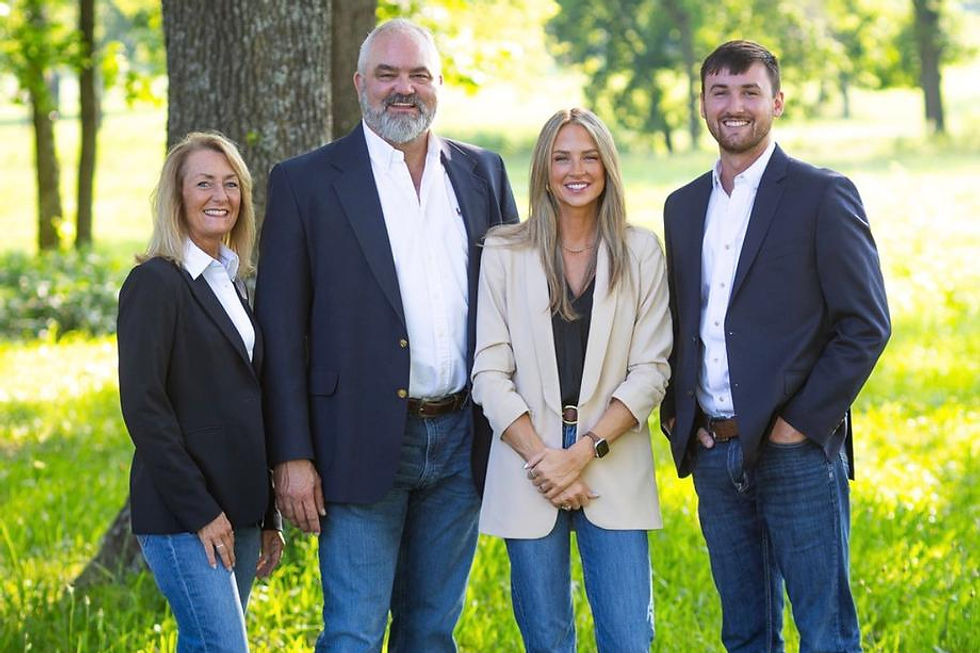 Four professionals from Our Firm posing outdoors.