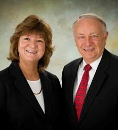 Smiling mature man and woman in professional business attire