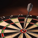 A dart hitting the bullseye on a dartboard.
