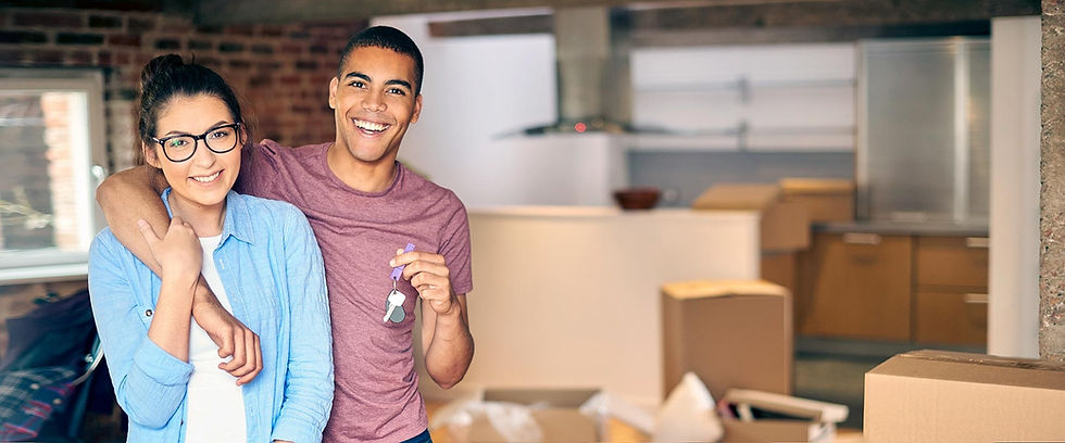 Smiling couple holding keys in their new home