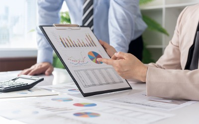 advisor and client discussing financial charts and graphs