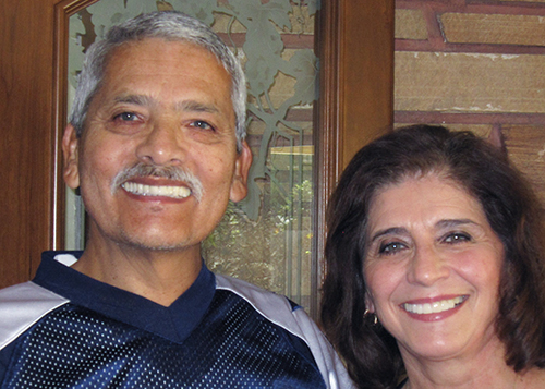 Smiling portrait of a man and woman in an indoor setting
