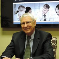 Smiling man in a suit at Candace Shira Associates, LLC.