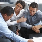Couple discussing unearned income tax with advisor