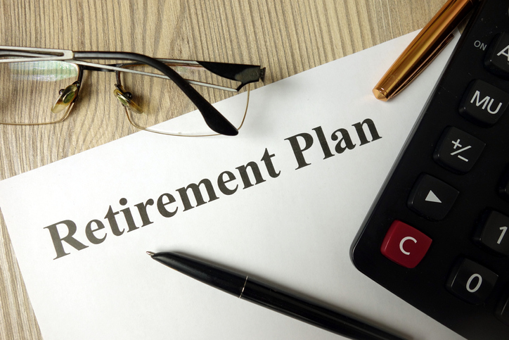 Retirement Plan document with glasses and calculator.