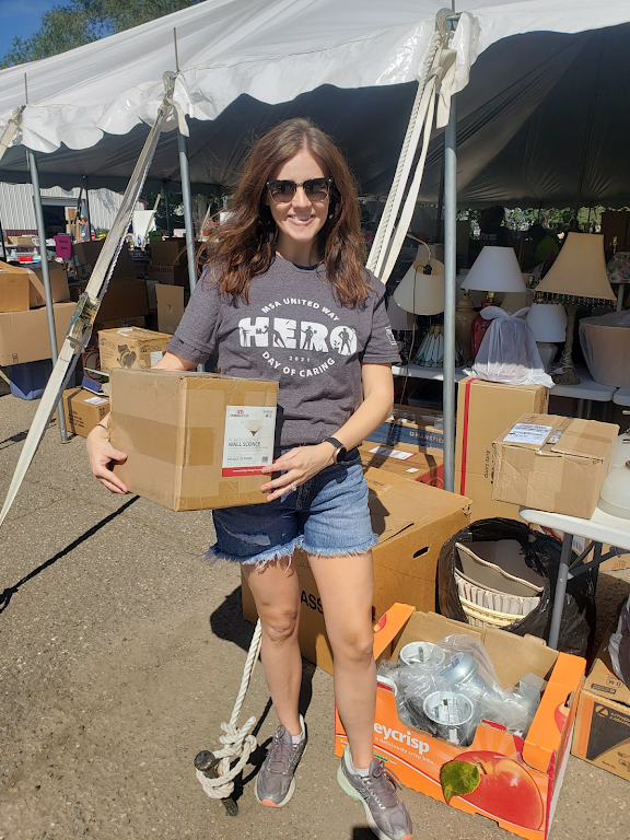 Woman in United Way HERO shirt holding a donation box